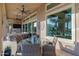 Stylish outdoor patio with a glass table, comfortable seating, and views of the lush backyard at 30404 N 131St Dr, Peoria, AZ 85383
