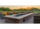 Relaxing outdoor space with a modern fire pit, comfortable seating, and serene natural surroundings at 30404 N 131St Dr, Peoria, AZ 85383