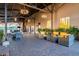 Covered outdoor patio with comfortable seating arrangements and views of the desert landscape at 30404 N 131St Dr, Peoria, AZ 85383