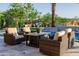 Cozy outdoor seating area with wicker furniture and a fire feature, ideal for entertaining guests at 30404 N 131St Dr, Peoria, AZ 85383