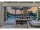 Inviting outdoor patio with a stunning view of the pool, palm trees, and lush landscaping, perfect for relaxation and entertainment at 30404 N 131St Dr, Peoria, AZ 85383