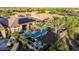 Aerial view of the backyard oasis with its pool, palm trees, and outdoor seating area at 30404 N 131St Dr, Peoria, AZ 85383