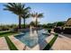 A stunning pool and spa area with travertine tile, complete with water feature and lush landscaping at 30404 N 131St Dr, Peoria, AZ 85383