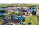 Aerial view of a sparkling pool with palm trees and solar panels on the roof at 30404 N 131St Dr, Peoria, AZ 85383
