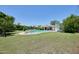 Spacious backyard with a sparkling pool surrounded by lush greenery and lawn at 325 W Loma Ln, Phoenix, AZ 85021