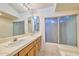 Bathroom featuring double sinks, tile countertops, and a window over the bathtub at 325 W Loma Ln, Phoenix, AZ 85021