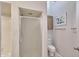Bathroom featuring a shower and white toilet with storage cabinet in an alcove at 325 W Loma Ln, Phoenix, AZ 85021