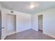 A bedroom with bare concrete flooring, white walls and trim, two closets and an overhead light fixture at 325 W Loma Ln, Phoenix, AZ 85021