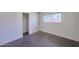 Bright, minimalist bedroom with a large window and closet creating a blank canvas for personal design at 325 W Loma Ln, Phoenix, AZ 85021