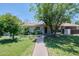 Charming home with a welcoming walkway, mature trees, and well-maintained landscaping creating great curb appeal at 325 W Loma Ln, Phoenix, AZ 85021