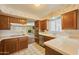 Functional kitchen with ample cabinet space, white countertops, and stainless-steel appliances, ready for your personal touch at 325 W Loma Ln, Phoenix, AZ 85021