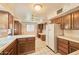 Bright kitchen with white tile countertops, wood cabinets, and a breakfast nook creating a classic, functional space at 325 W Loma Ln, Phoenix, AZ 85021