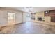 Inviting living room with a brick fireplace, ceiling fan, and sliding glass door, perfect for relaxation and entertaining at 325 W Loma Ln, Phoenix, AZ 85021