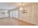 Inviting living room with a chandelier and shuttered window, accentuated by artwork at 325 W Loma Ln, Phoenix, AZ 85021