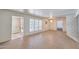 Spacious living room with shutters, a chandelier, and doorways leading to other areas of the home at 325 W Loma Ln, Phoenix, AZ 85021