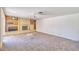 Spacious living room featuring a brick fireplace, built-in shelves, and a ceiling fan for added comfort at 325 W Loma Ln, Phoenix, AZ 85021