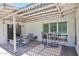 Inviting covered patio with lattice work, outdoor dining set, and bar, perfect for entertaining at 325 W Loma Ln, Phoenix, AZ 85021