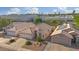 An aerial view of single-Gathering homes featuring desert landscaping and tile roofs in a vibrant community at 3338 E Lavey Ln, Phoenix, AZ 85032