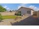Enclosed backyard featuring rock landscaping, desert plants, and a covered patio at 3338 E Lavey Ln, Phoenix, AZ 85032