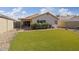 Low-maintenance backyard with artificial turf, mature plants, and a covered patio at 3338 E Lavey Ln, Phoenix, AZ 85032