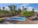Well-maintained community basketball court surrounded by mature trees and gravel at 3338 E Lavey Ln, Phoenix, AZ 85032