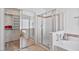Bathroom featuring a modern shower, bathtub, and walk-in closet at 3338 E Lavey Ln, Phoenix, AZ 85032