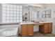 Bright bathroom with tiled floors, and dual sinks set in a modern cabinet at 3338 E Lavey Ln, Phoenix, AZ 85032