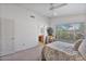 Spacious bedroom with a ceiling fan, sitting area, and bathroom access at 3338 E Lavey Ln, Phoenix, AZ 85032