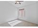 Minimalist bedroom featuring neutral carpet and walls, with a single window providing natural light at 3338 E Lavey Ln, Phoenix, AZ 85032