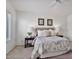Well-lit bedroom featuring a decorative bed, stylish lamps, and a window at 3338 E Lavey Ln, Phoenix, AZ 85032