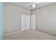 Neutral bedroom with a ceiling fan, closet with double doors, and neutral carpet at 3338 E Lavey Ln, Phoenix, AZ 85032