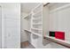 Walk-in closet with custom shelving and rods, great for organization and storage at 3338 E Lavey Ln, Phoenix, AZ 85032