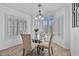 Bright dining room featuring large windows, a glass table, and comfortable seating for elegant meals at 3338 E Lavey Ln, Phoenix, AZ 85032