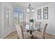 Dining area featuring a glass table, comfortable chairs, and ample natural light at 3338 E Lavey Ln, Phoenix, AZ 85032