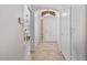 Bright entryway showcasing neutral tile flooring, an arched doorway, and a view into the dining room at 3338 E Lavey Ln, Phoenix, AZ 85032