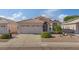 Charming single-story home featuring a tile roof, a two-car garage, and desert landscaping at 3338 E Lavey Ln, Phoenix, AZ 85032