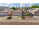 Charming single-story home featuring a tile roof, a two-car garage, and desert landscaping at 3338 E Lavey Ln, Phoenix, AZ 85032