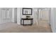Welcoming foyer with neutral walls and carpet, highlighted by a console table and an inviting doorway at 3338 E Lavey Ln, Phoenix, AZ 85032