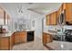 Well-lit kitchen featuring wood cabinets, granite countertops, and stainless-steel appliances at 3338 E Lavey Ln, Phoenix, AZ 85032