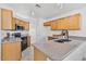 Practical kitchen featuring wooden cabinetry, granite countertops, and efficient appliances at 3338 E Lavey Ln, Phoenix, AZ 85032