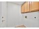 Utility room featuring tile flooring, storage cabinets, and door with gold hardware at 3338 E Lavey Ln, Phoenix, AZ 85032