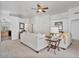 Spacious living room featuring neutral paint, carpet, a ceiling fan, and access to the kitchen at 3338 E Lavey Ln, Phoenix, AZ 85032