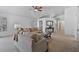 Bright living room featuring neutral walls, carpet, and ample seating with a ceiling fan at 3338 E Lavey Ln, Phoenix, AZ 85032