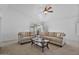 Inviting living room featuring neutral walls and carpet, complemented by cozy seating and natural light at 3338 E Lavey Ln, Phoenix, AZ 85032