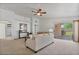 Spacious living room featuring neutral paint, carpet, a ceiling fan, and sliding glass doors to the backyard at 3338 E Lavey Ln, Phoenix, AZ 85032