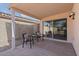 Covered patio with seating area and sliding glass doors leading to the interior at 3338 E Lavey Ln, Phoenix, AZ 85032