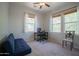 Bedroom with neutral paint, carpet, and two large windows at 34979 N 30Th Ave, Phoenix, AZ 85086