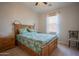 Inviting bedroom with a wooden bed frame, palm tree bedding, bedside tables, carpet flooring and natural light at 34979 N 30Th Ave, Phoenix, AZ 85086