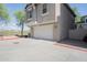Two-story home showing the two-car tandem garage and driveway, complete with desert landscaping at 34979 N 30Th Ave, Phoenix, AZ 85086