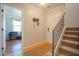 Foyer with hardwood floors, coat rack, staircase, and an open view into the front living room at 34979 N 30Th Ave, Phoenix, AZ 85086